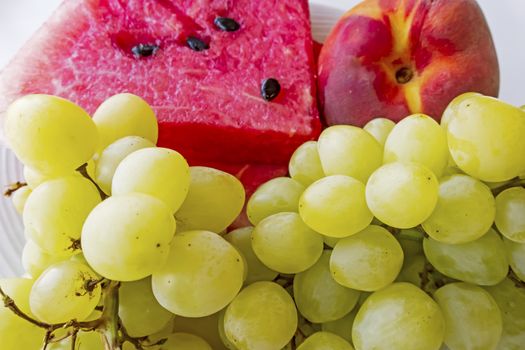 peaches, watermelons, and grape fruits on plate