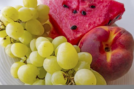 peaches, watermelons, and grape fruits on plate