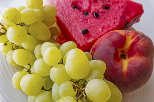 peaches, watermelons, and grape fruits on plate