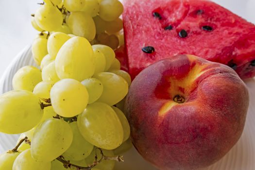 peaches, watermelons, and grape fruits on plate