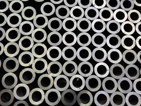 abstract dark industrial background of sawed steel pipes ends - flat and full frame.