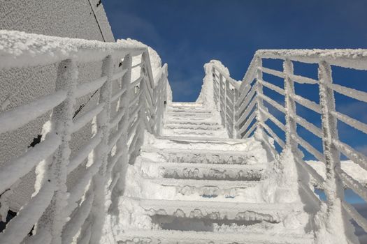 Snow and ice covered stairs and windows illustrating extreme cold in the winter. Jasna, Slovakia.