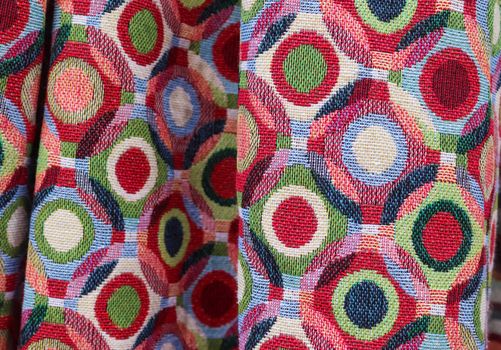 Detailed close up view on samples of cloth and fabrics in different colors found at a fabrics market.