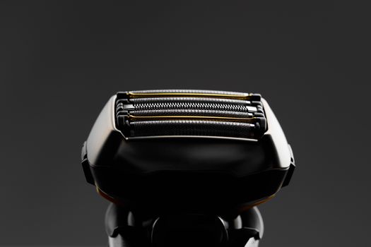 electric razor foil shaver mesh and blades, close-up view, dark background