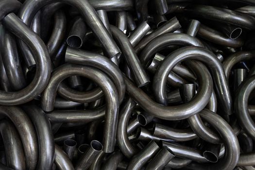 abstract black industrial full frame background of bended steel pipes.