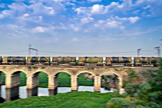 Panning , blur image of petrol tanker train passing on old bridge in Dapodi, Pune, India.