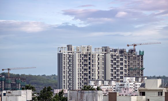 Twin, tall buildings under construction in Pune, Maharashtra, India.