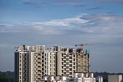 Twin, tall buildings under construction in Pune, Maharashtra, India.