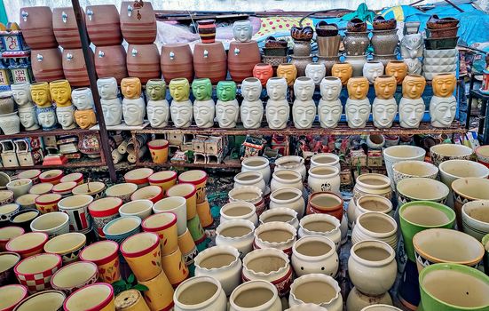 Decorative,colorful ceramic pots of different shapes and sizes, arranged in a roadside shop.