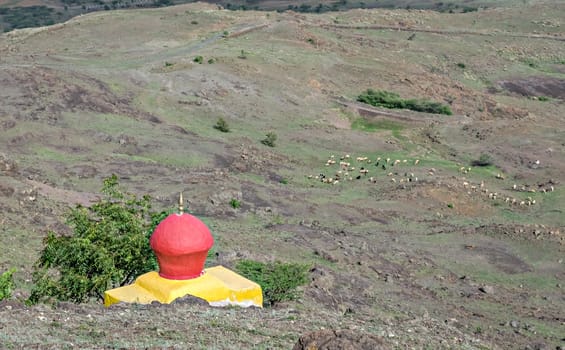 Brightly painted red dome of yellow temple on Dhavalgad fort, Purandar near Pune, Maharashtra, India.