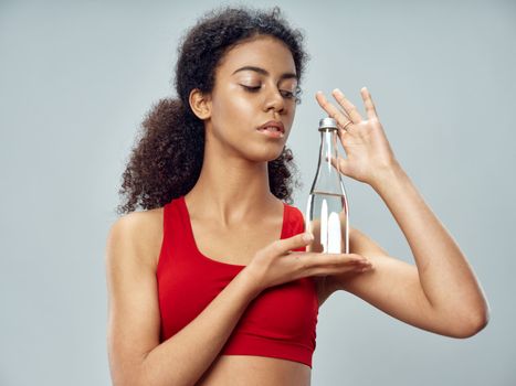 Sporty woman holding a water bottle in her hands health gym workout