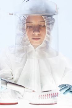 Scientist working in the corona virus vaccine development laboratory research with a highest degree of protection gear. Coronavirus pandemic concept. Development of virus treatment drug.