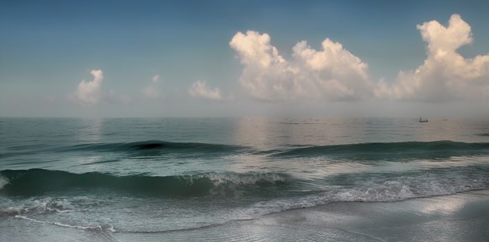 Panoramic view of waves breaking on shore 