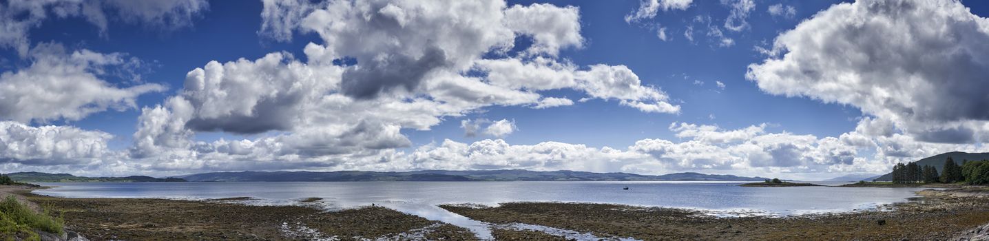 Panoramic view of rocks and boulders on the shore of the Firth of Clyde on the West coast of Scotland
