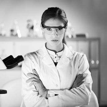 Portrait of a attractive, young, confident female health care professional in hes working environment. Black and white image.