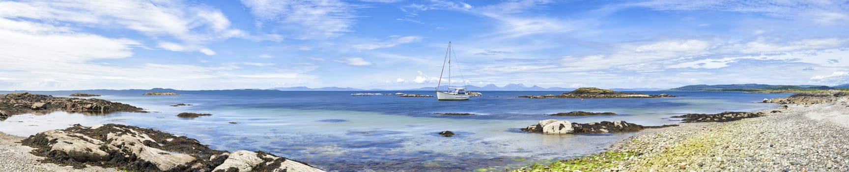 Panoramic view of sailing boat moored at Ronachan Point, Kintyre off the West coast of Scotland