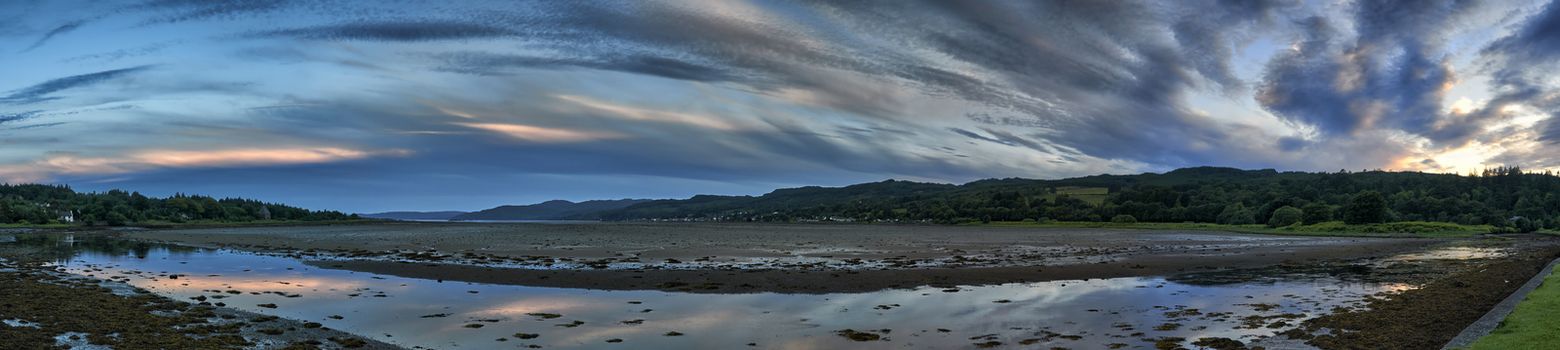 Panoramic view looking down estuary of sunset over Lochgilphead,Scotland at low tide