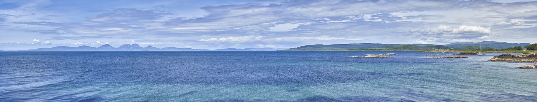 Panoramic view of sailing boat moored at Ronachan Point, Kintyre off the West coast of Scotland