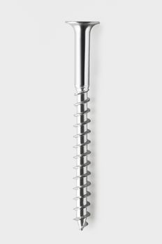 Overhead view of a single screw isolated on white background