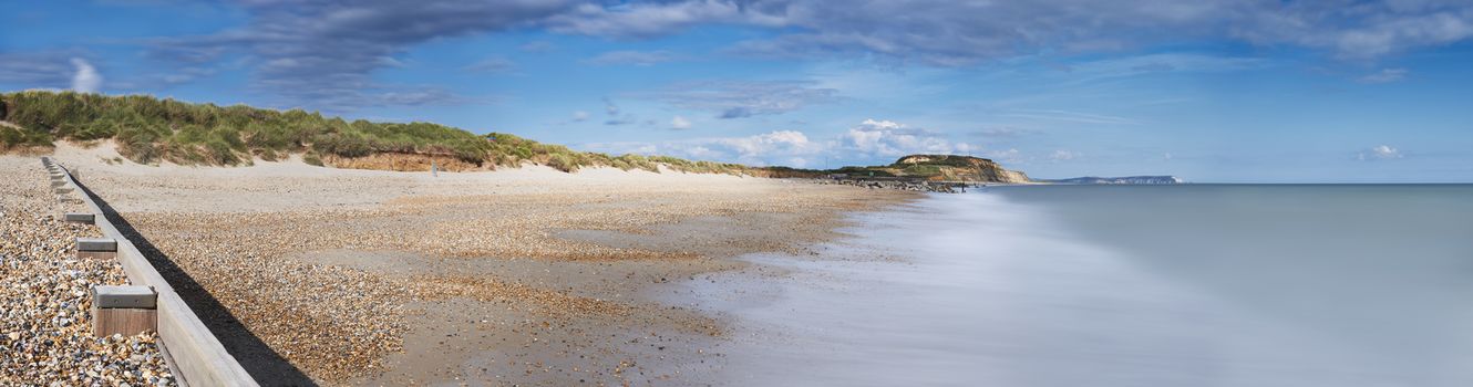Panoramic view of Hengistbury Head beach, Dorset with groyne in the foreground and Isle of Wright Needles in background