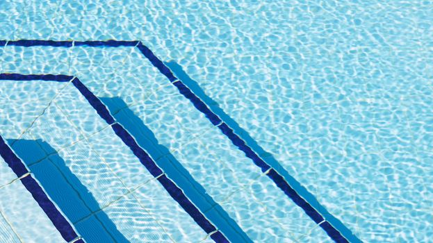 Overhead photography of ripples of water by steps in swimming pool