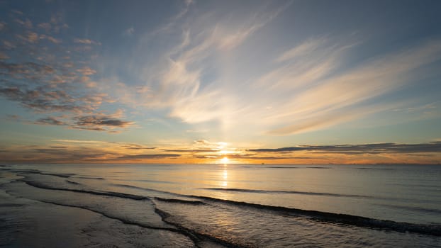Sunrise shot over the sea and beautiful cloud. sun disappeared behind a big cloud over ocean.