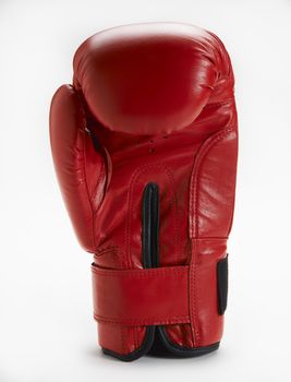 Red boxing glove standing upright on white background