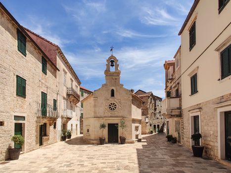 Small church on square of small urban village of Stari grad on Hvar island in Croatia, Adriatic Sea, Europe.