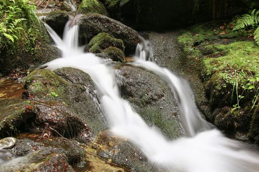 Abstract detail of the water flowing over rocks