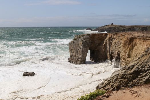 Spectacular cliffs and stone arch Arche de Port Blanc on famous coastline Cote Sauvage, Quiberon, Brittany (Bretagne), France