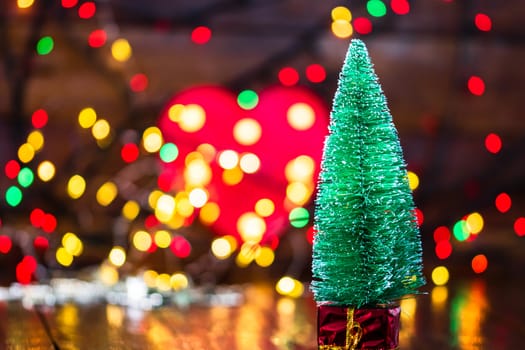 Decorations and ornaments in a colorful Christmas composition isolated on background of blurred lights.