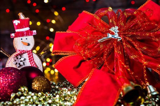 Decorations and ornaments in a colorful Christmas composition isolated on background of blurred lights.