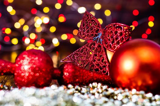 Decorations and ornaments in a colorful Christmas composition isolated on background of blurred lights.