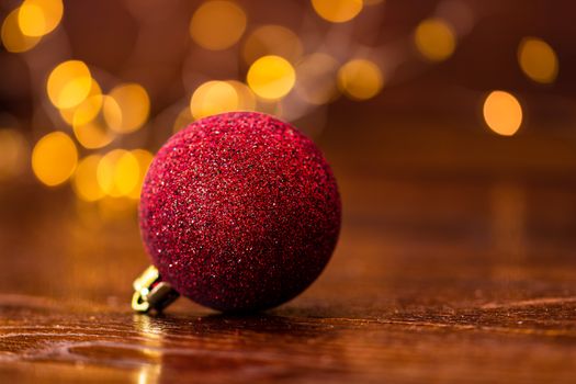 Colorful Christmas ball isolated on blurred and shiny background of lights. Christmas baubles isolated.