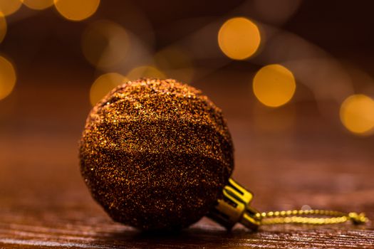 Colorful Christmas ball isolated on blurred and shiny background of lights. Christmas baubles isolated.