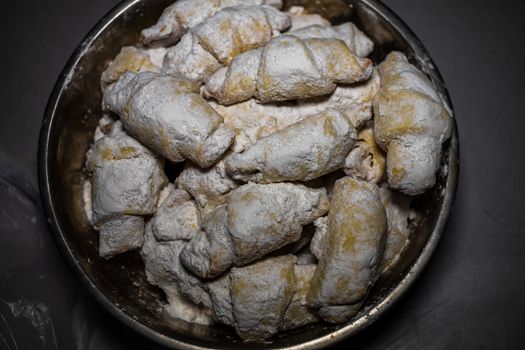 Shortcrust pastry crescent rolls croissants, romanian cornulete with powdered sugar close up isolated