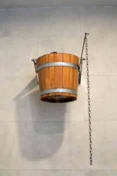 wooden bucket on the wall for pouring cold water in the sauna.