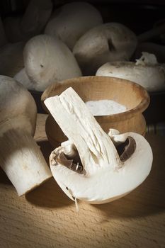 Fresh mushrooms champignons close-up on a wooden surface