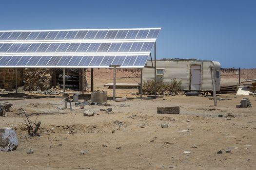 Off-grid solar installation in a messy trailer park. Renewable and carbon neutral energy