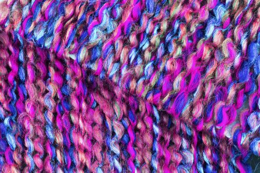 A macro of pink and blue wool yarn texture
