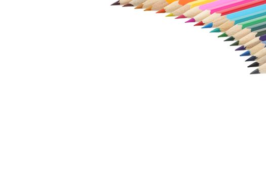 A top right corner border of multi colored pencils with copy space