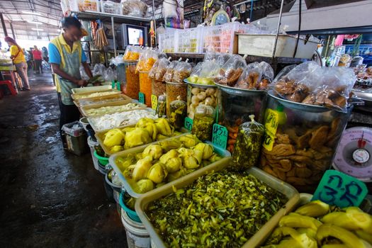 Khao Lak, Thailand - February 22, 2016: Variety of fresh fruit and vegetables products displayed on local food market in the morning. Thai cuisine is renowned for its tasty food ingredients.