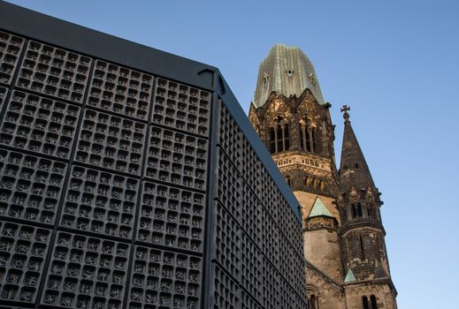 Berlin, Germany - September 09, 2007: Broken tower of Kaiser Wilhelm Memorial Church (Gedachtniskirche) with belfry in front - church was not rebuild as a reminder of world war II.