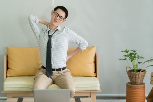 Young Asian man is sick From pain in the neck and back. A handsome businessman is tired and stressed by hard work. Online doctor consultation Distance with communication technology, connection concept