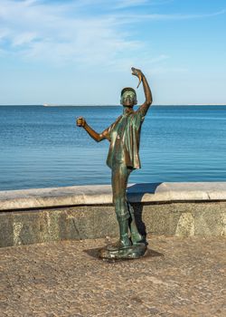 Berdyansk, Ukraine 07.23.2020. Monument to the fisherman on the embankment of Berdyansk, Ukraine, on a sunny summer morning