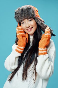 Woman in winter hat with gloves white sweater cool fun
