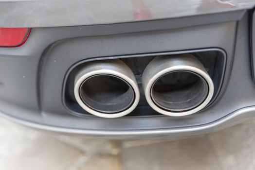 a cylindrical double sports car exhaust