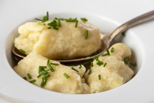 closeup of semolina dumplings in broth