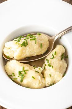 closeup of semolina dumplings in broth