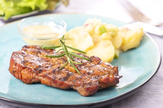 grilled pork steak with potato salad